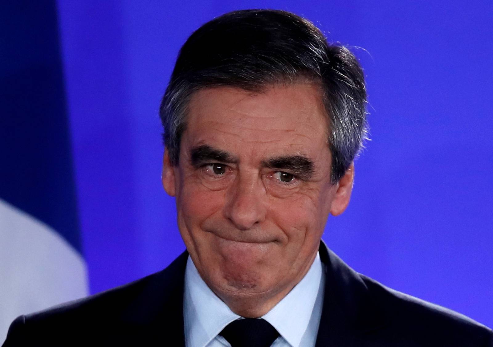 FILE PHOTO: Francois Fillon, member of the Republicans political party and 2017 French presidential election candidate of the French centre-right, reacts as he delivers a speech at his campaign headquarters in Paris