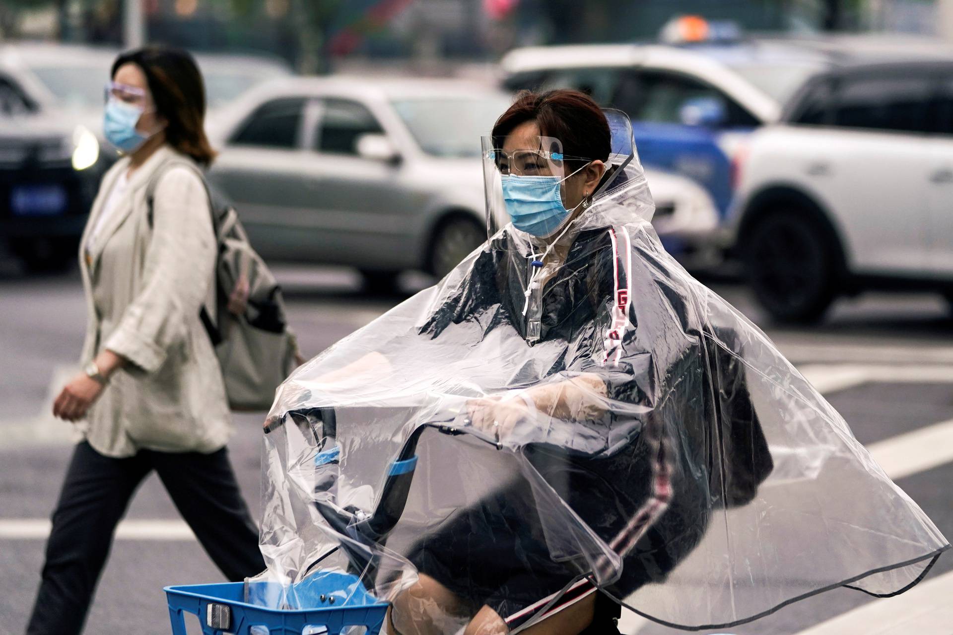 People wearing protective face masks are seen on a street in Wuhan