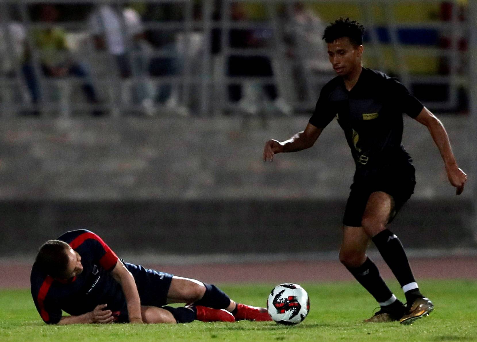 Ezzeldin Bahader, a 74-years-old Egyptian football player of 6th October Club falls down during a soccer match against El Ayat Sports Club of Egypt's third division league at the Olympic Stadium in the Cairo suburb of Maadi