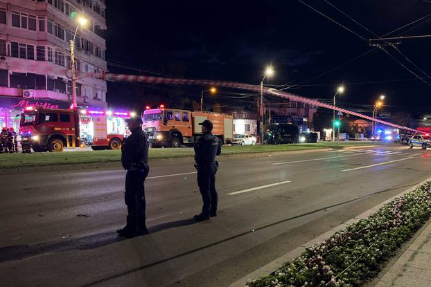 Firefighters and law enforcement work on the site of an explosion at a residential block of flats following a drone hit close to the border with Ukraine