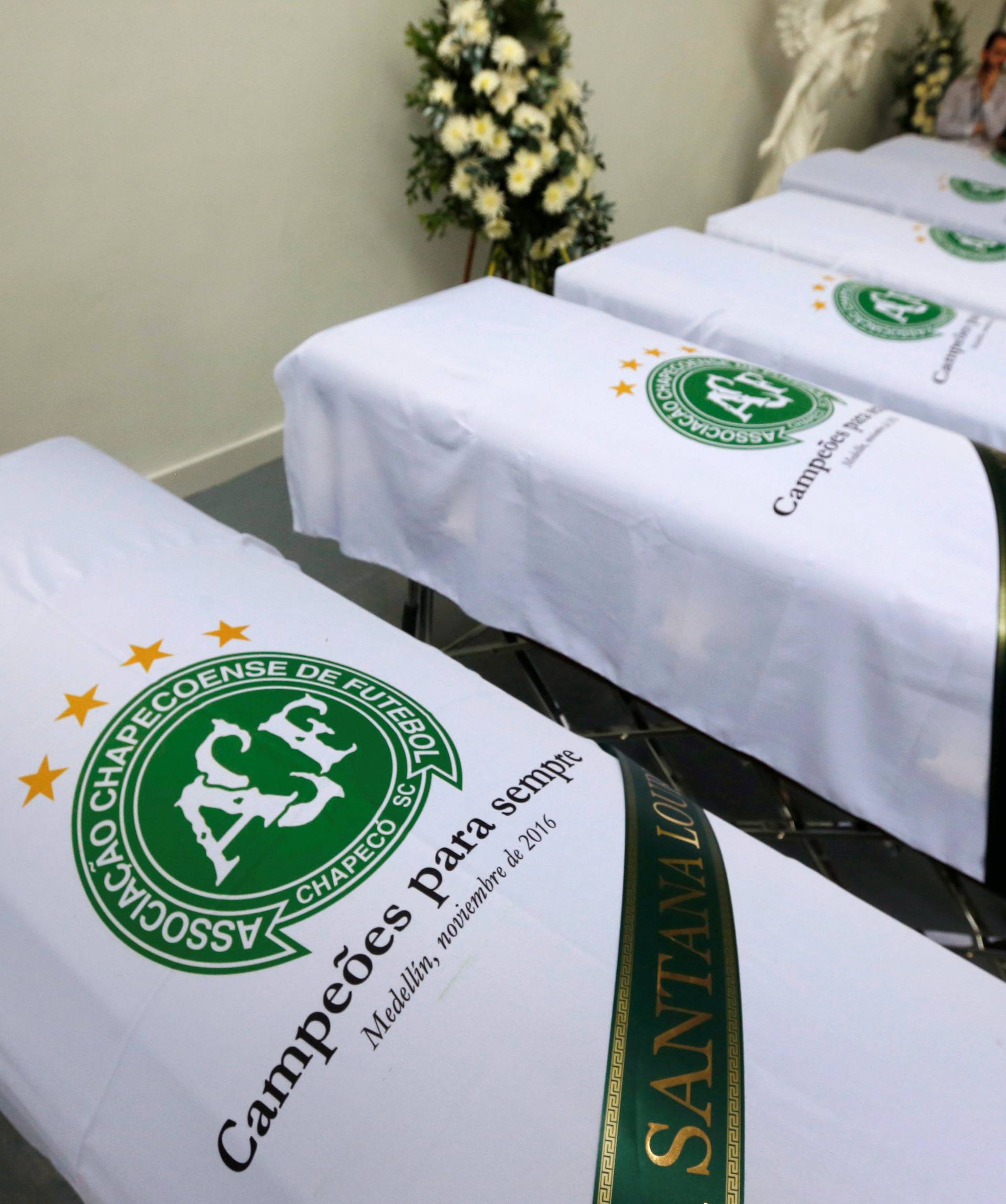 Blankets bearing the crest of Brazilian soccer team Chapecoense are placed on coffins holding the remains of the victims who died in an accident of the plane that crashed into the Colombian jungle with the team's players onboard, in Medellin