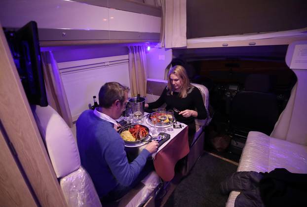 Customers enjoy dinner sitting inside a motorhome camper parked at the Belgian restaurant Matthias And Sea, despite the COVID-19 pandemic lockdown in Tarcienne