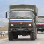 Vehicles of Russian peacekeepers leaving Nagorno-Karabakh region pass an Armenian checkpoint near Kornidzor