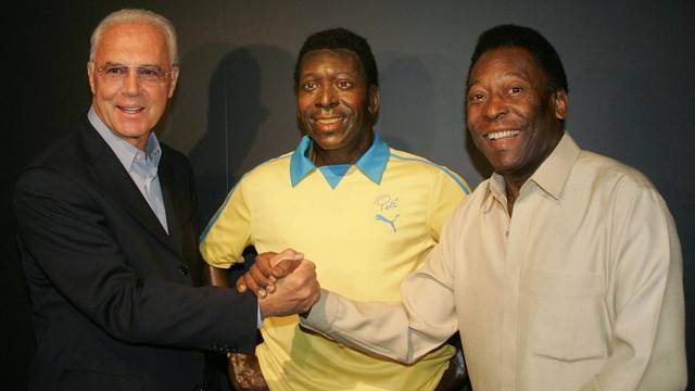 FILE PHOTO: Soccer legend Pele of Brazil poses with former German player Beckenbauer during their visit to the exhibition 'Pelestation' in Berlin