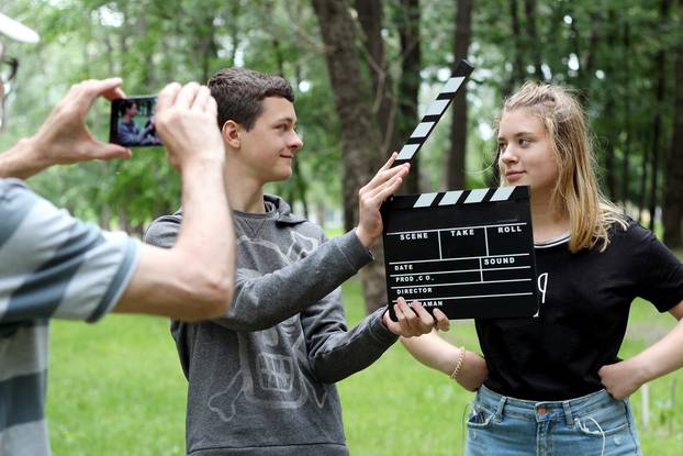 Teenage,Boy,With,Realistic,Clapper,Cinema,Board,Ready,To,Record