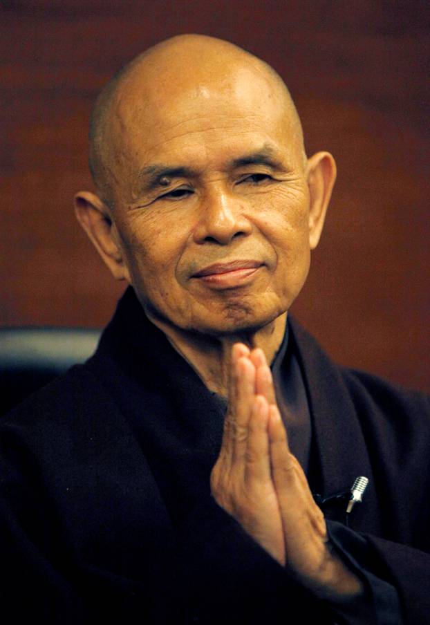 FILE PHOTO: French-based Buddhist zen master Thich Nhat Hanh gestures during his arrival at Suvarnabhumi airport in Bangkok