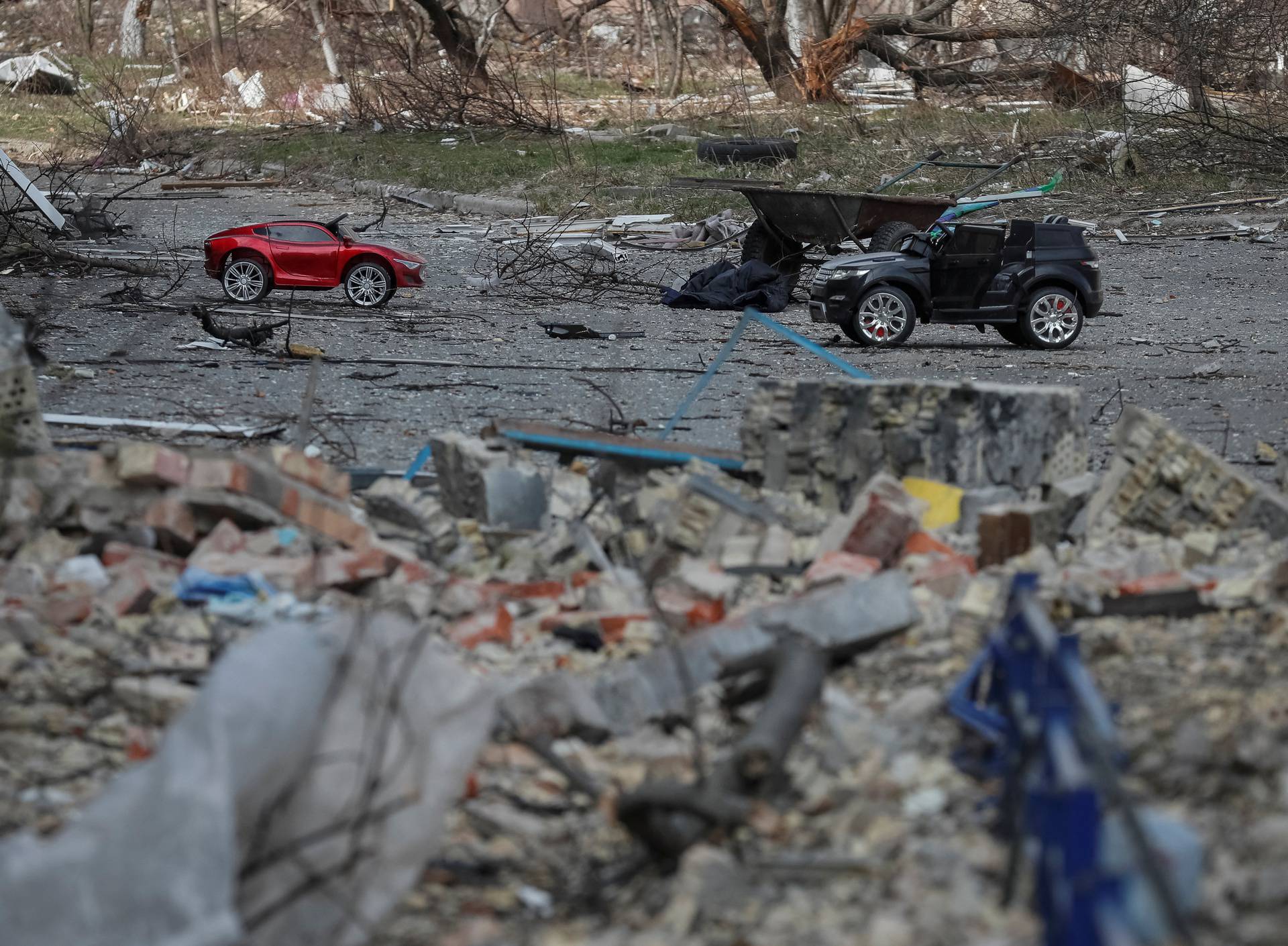 Toy cars are seen in the yard of the destroyed house on the front line near Kyiv