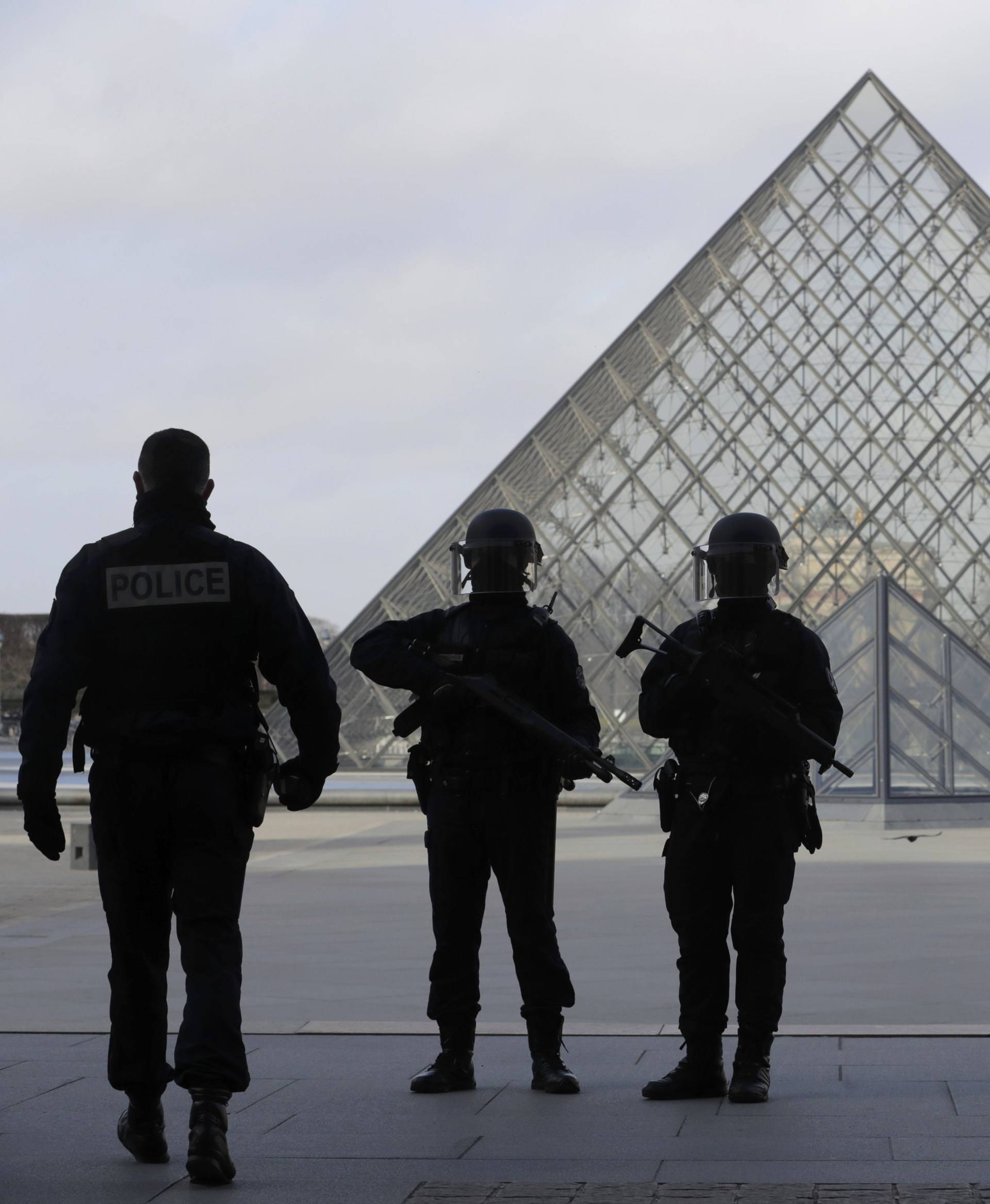 French police secure the site near the Louvre Pyramid in Paris