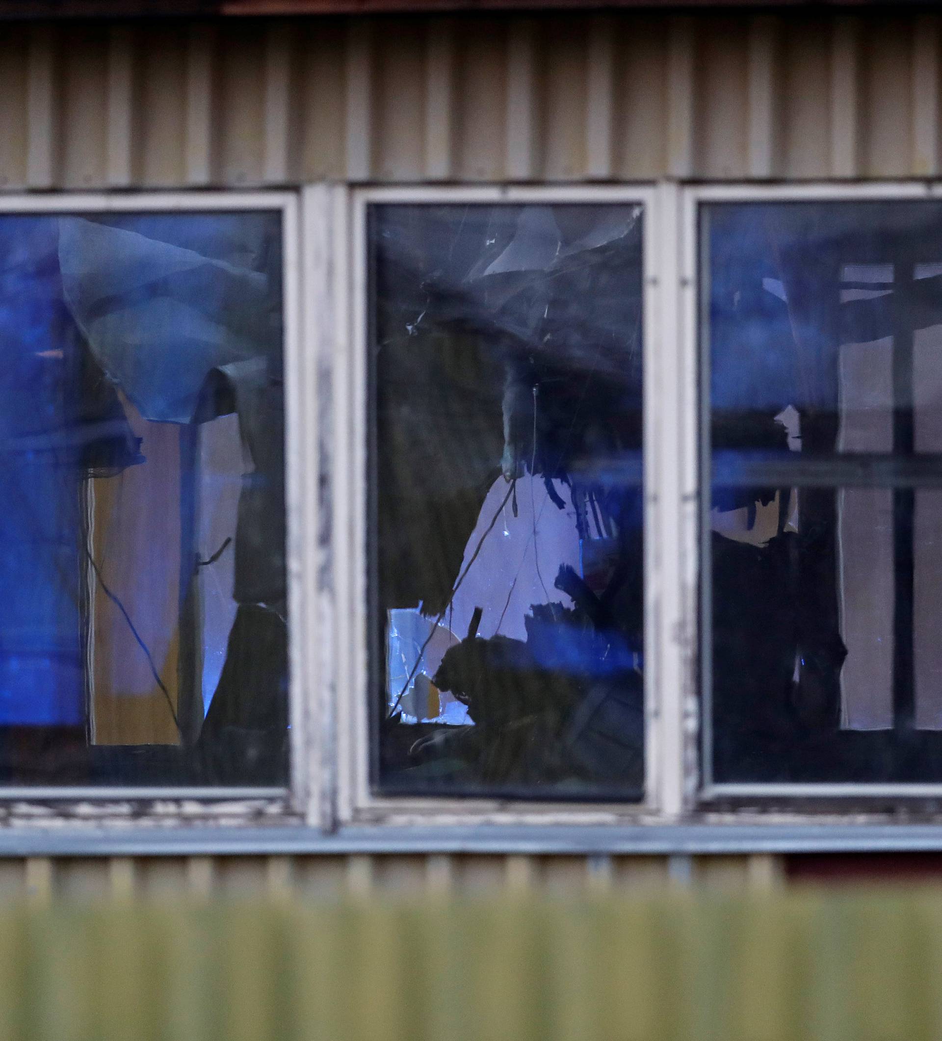 The wreckage of a small helicopter that crashed into an industrial hall is seen on the crash site in Plzen