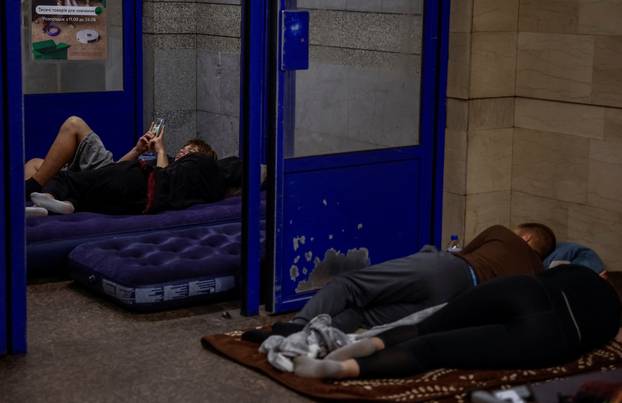 People take shelter inside a metro station during an air raid alert in Kyiv
