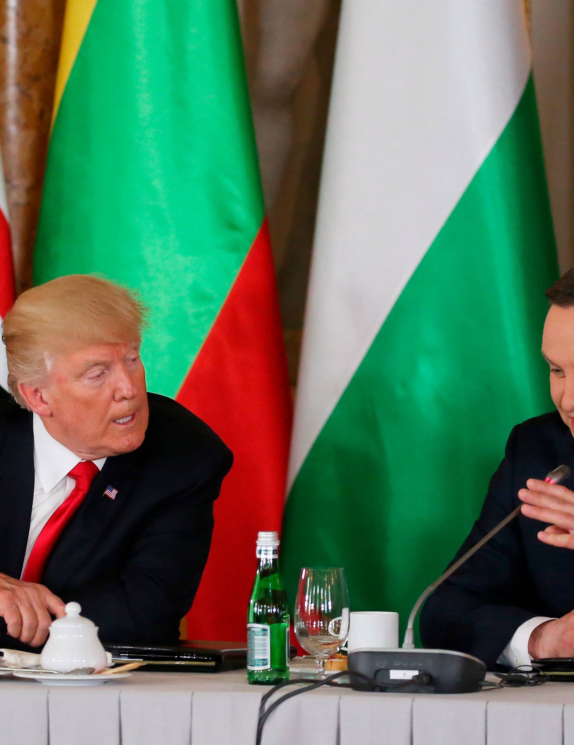U.S. President Donald Trump talks to Polish President Andrzej Duda during the Three Seas Initiative Summit in Warsaw
