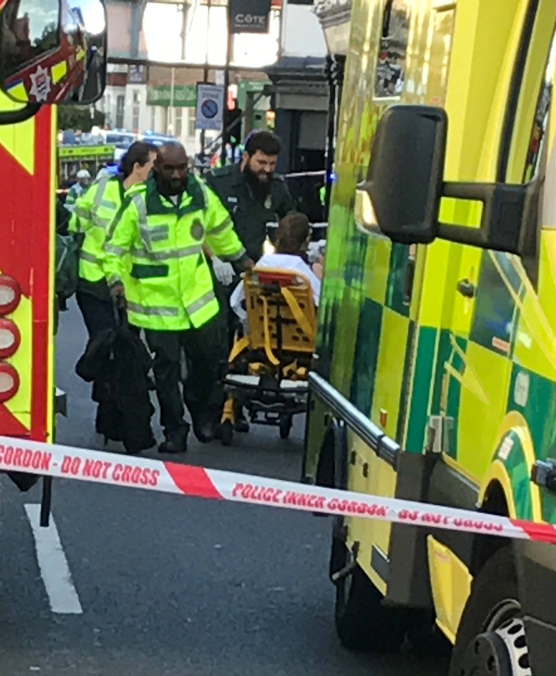 Emergency personnel attend to a person after an incident at Parsons Green underground station in London