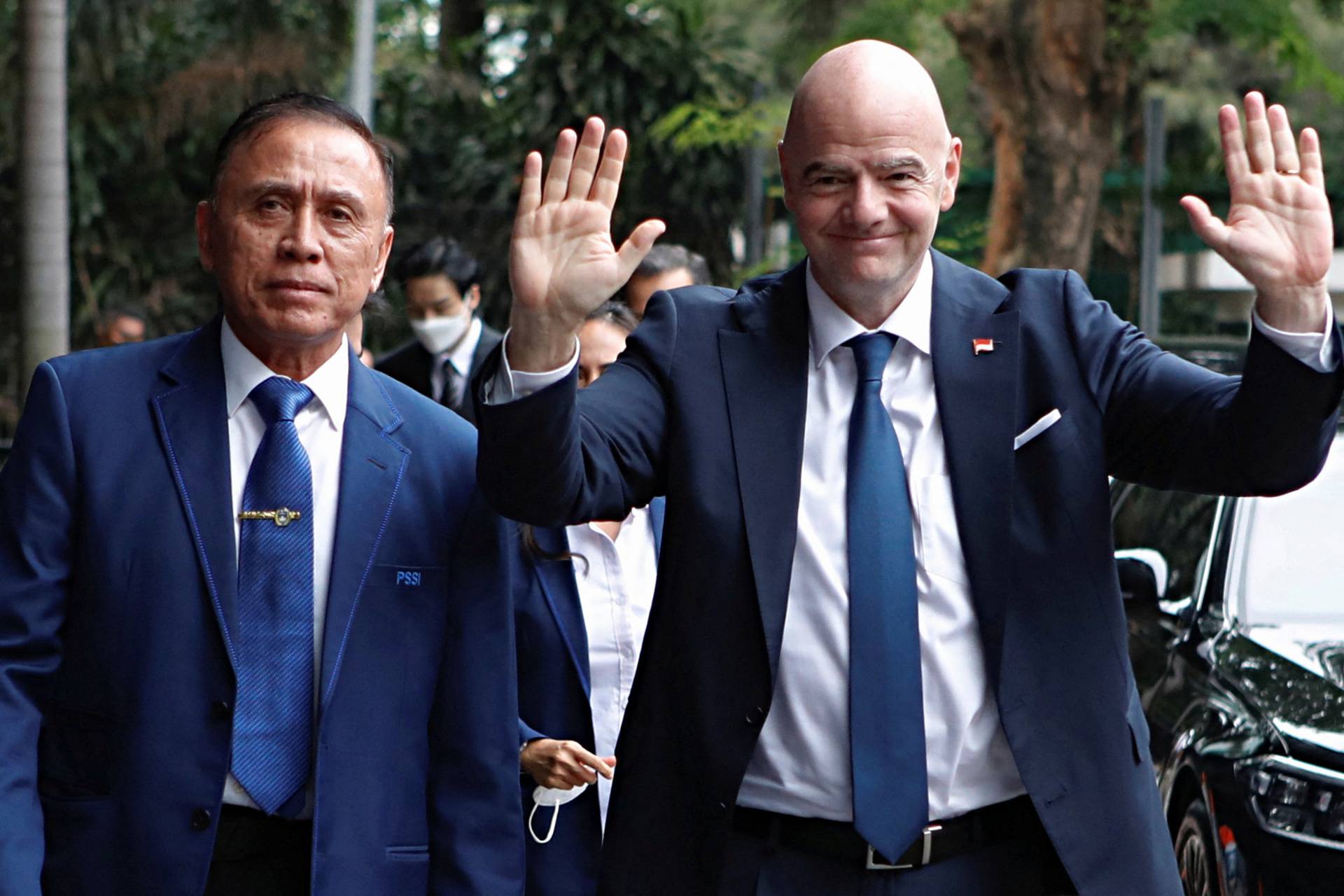 Chairman of the Indonesian Football Association (PSSI) Mochamad Iriawan and FIFA's president Gianni Infantino arrive at PSSI headquarters in Jakarta