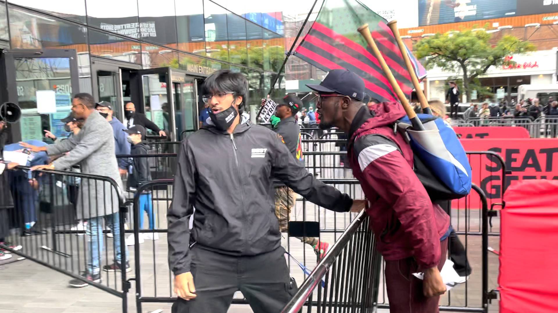 A demonstrator reacts towards a security guard outside the Barclays Center in New York