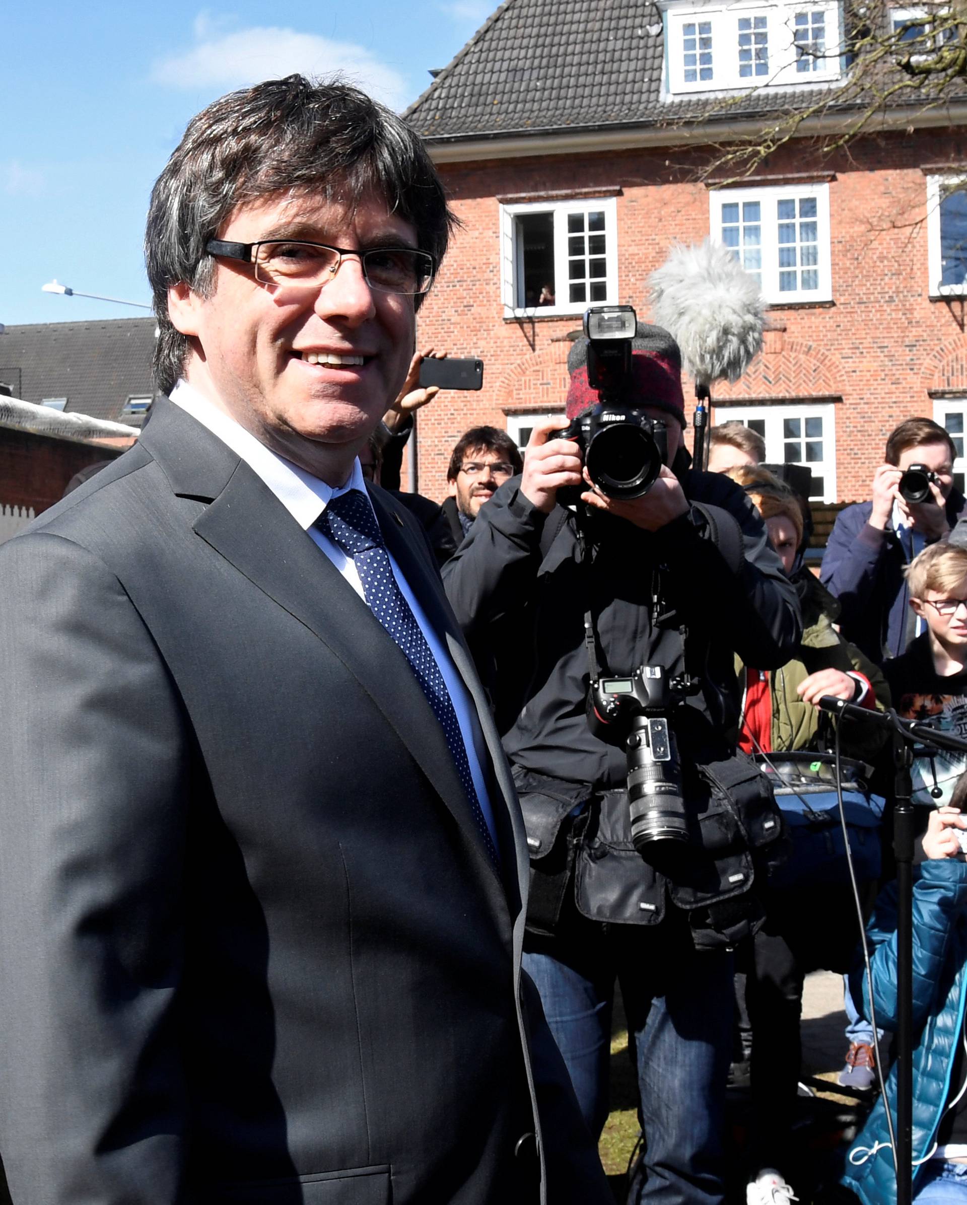 Catalonia's former leader Carles Puigdemont looks on as he leaves the prison in Neumuenster