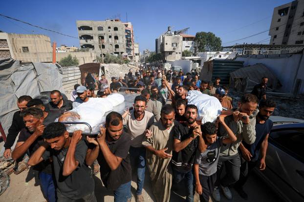 Mourners attend the funeral of Palestinians killed in overnight Israeli airstrikes, in Gaza City