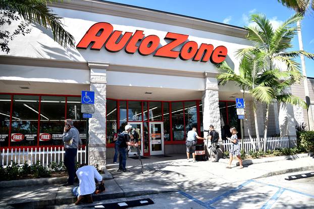 Members of the media are seen outside the Auto Zone store where a suspect involved in an investigation into a string of parcel bombs was apprehended, in Plantation, Florida