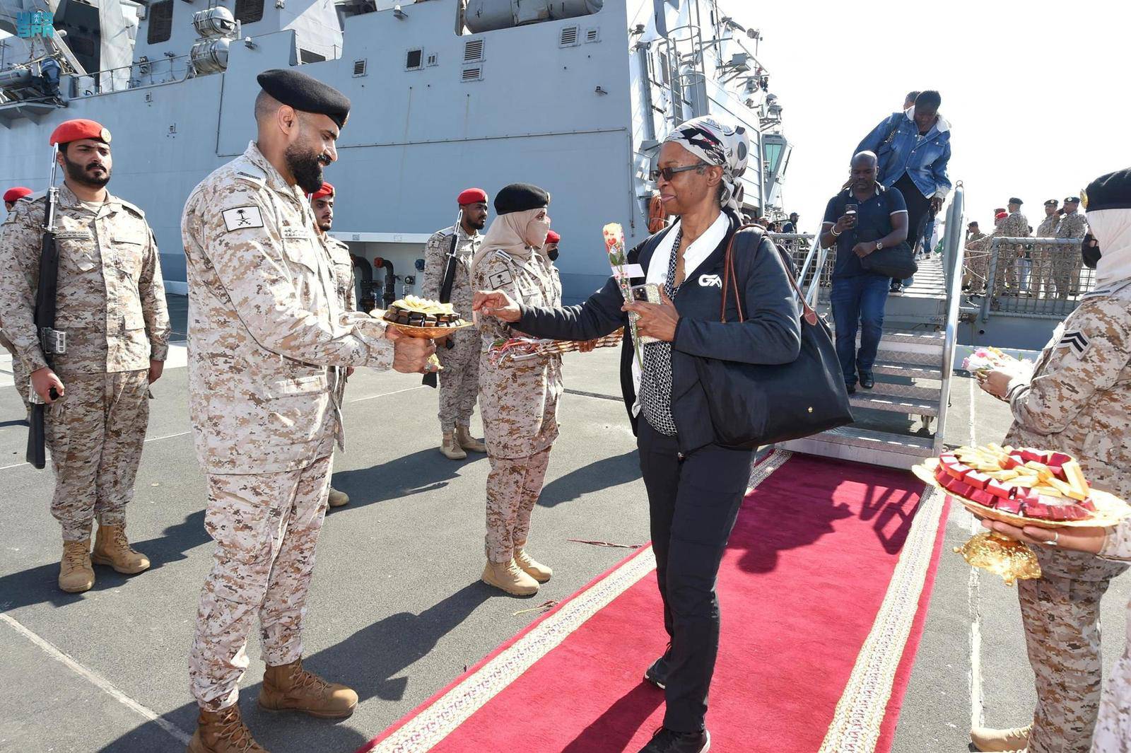 Citizens of Saudi Arabia and people from other nationalities are welcomed by Saudi Royal Navy officials as they arrive after being evacuated from Sudan at Jeddah Sea Port
