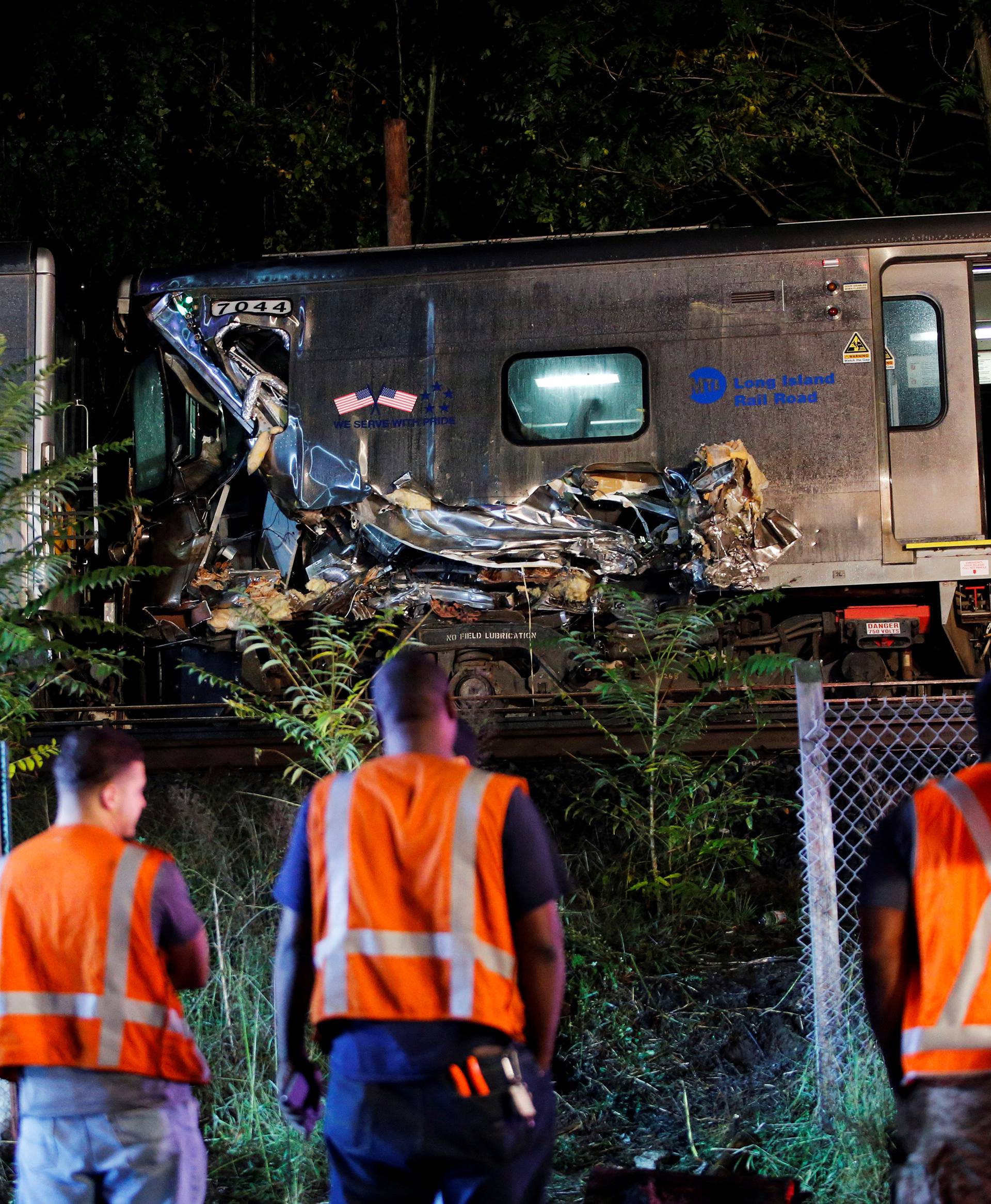 Emergency responders attend to a call of a train derailed near the community of New Hyde Park on Long Island in New York