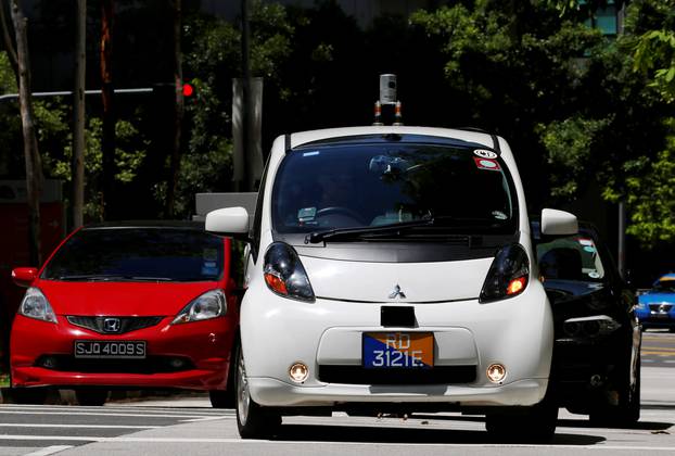 A nuTonomy self-driving taxi drives on the road in its public trial in Singapore 