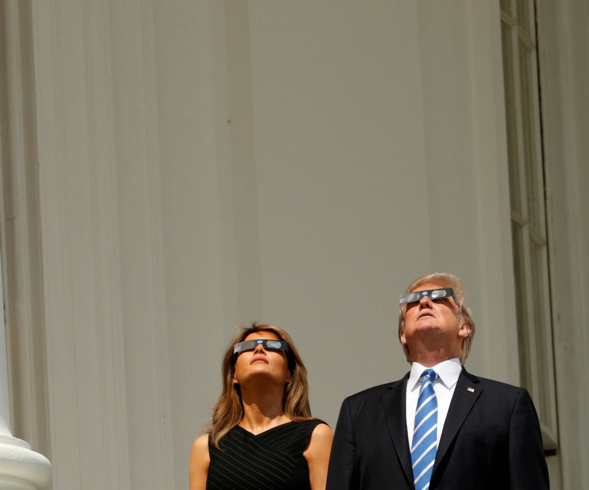 U.S. President Donald Trump and Melania Trump watch the solar eclipse from the White House in Washington