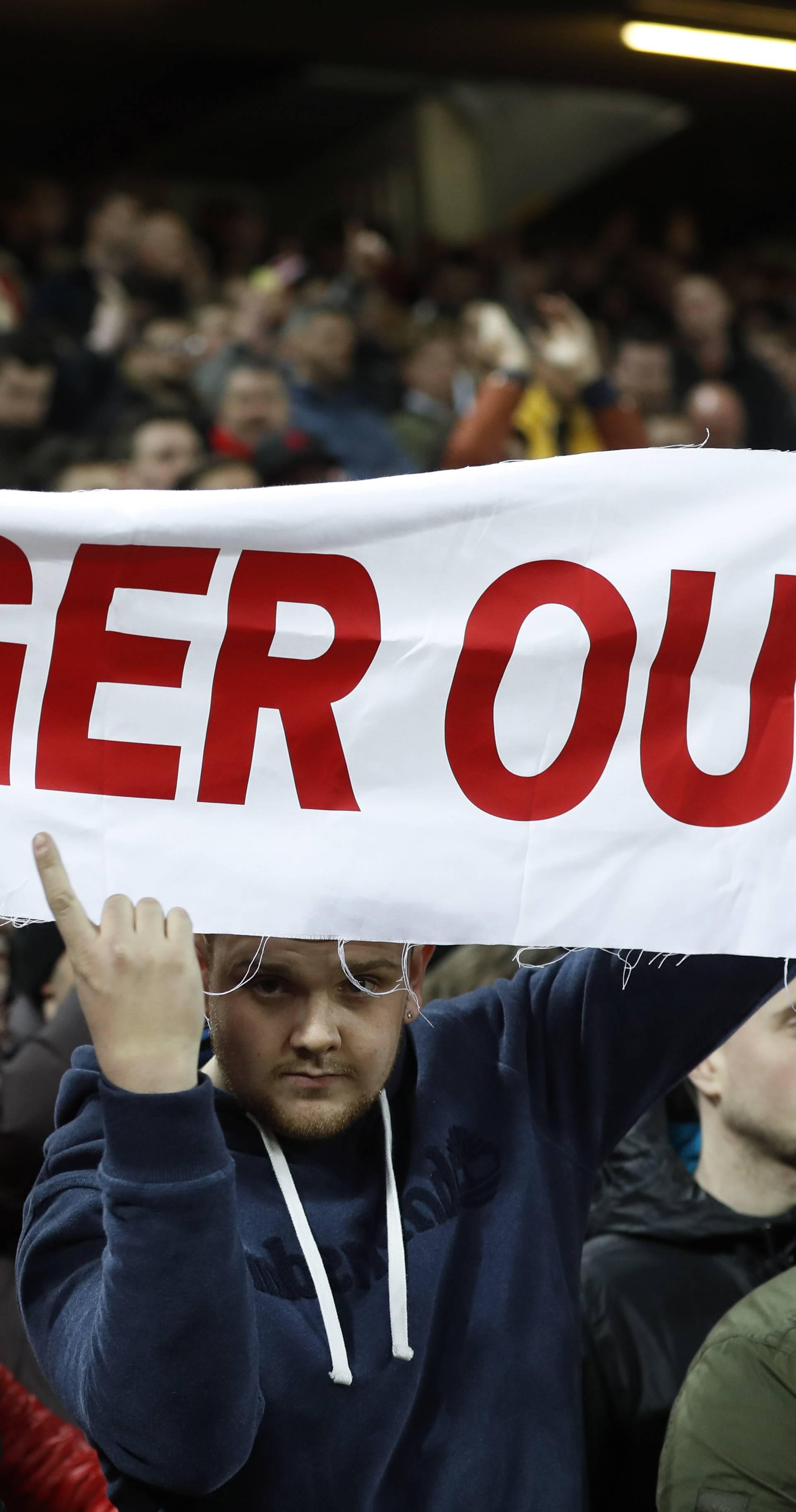 Arsenal fans protest with a banner against Arsenal manager Arsene Wenger