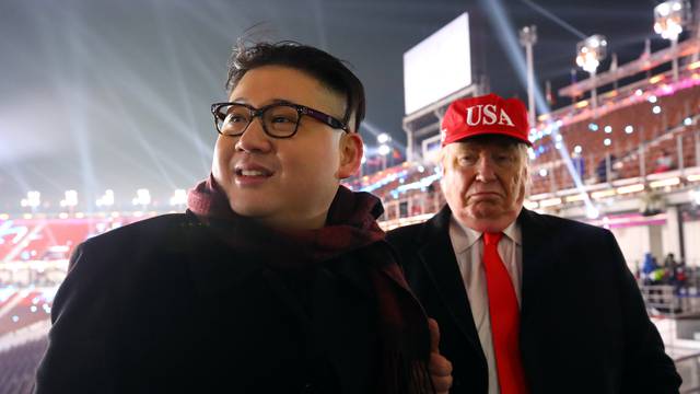 People dressed-up as U.S. President Donald Trump and North Korean leader Kim Jong Un attend the Winter Olympics opening ceremony in Pyeongchang