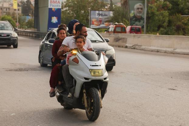 Displaced people make their way as they return to their home after a 10-day ceasefire between Lebanon and Israel went into effect, near Sidon