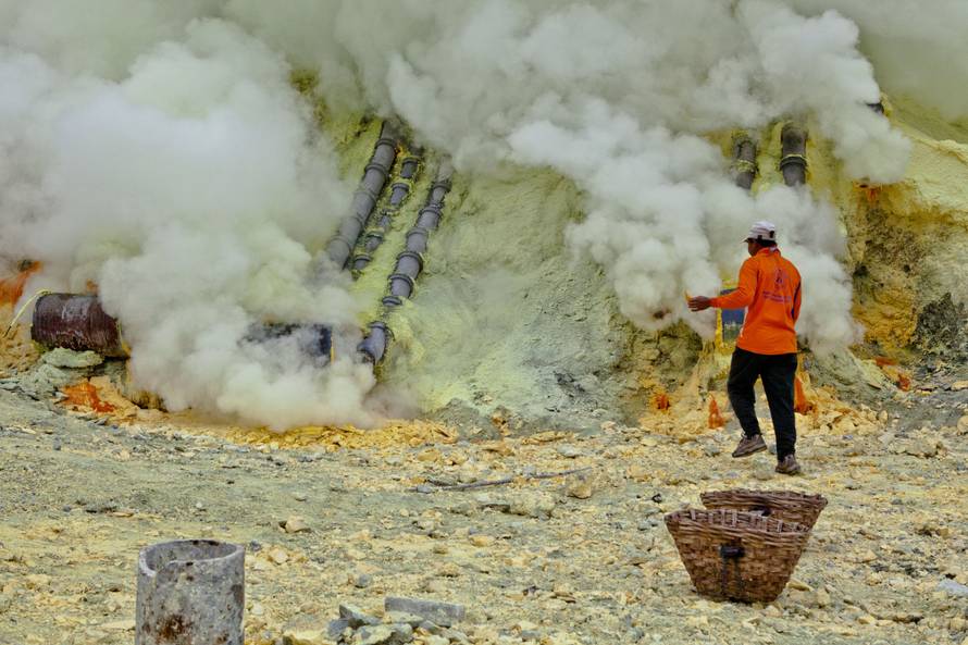 Sulfur workers at Kawa Ijen volcano in the sulfur mine, Kawa Ijen Plateau East Java Indonesia, Pacif