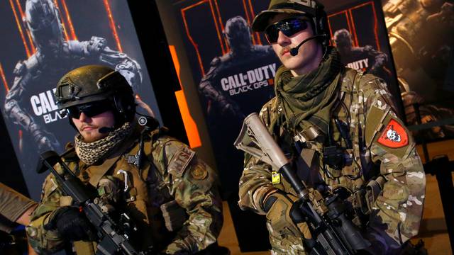 Men are dressed as soldiers to promote the video game "Call Of Duty Black Ops 3" at the Gamescom fair in Cologne