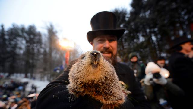 Punxsutawney Phil's co-handler AJ Dereume holds the famous groundhog on the 133rd Groundhog Day in Punxsutawney, Pennsylvania