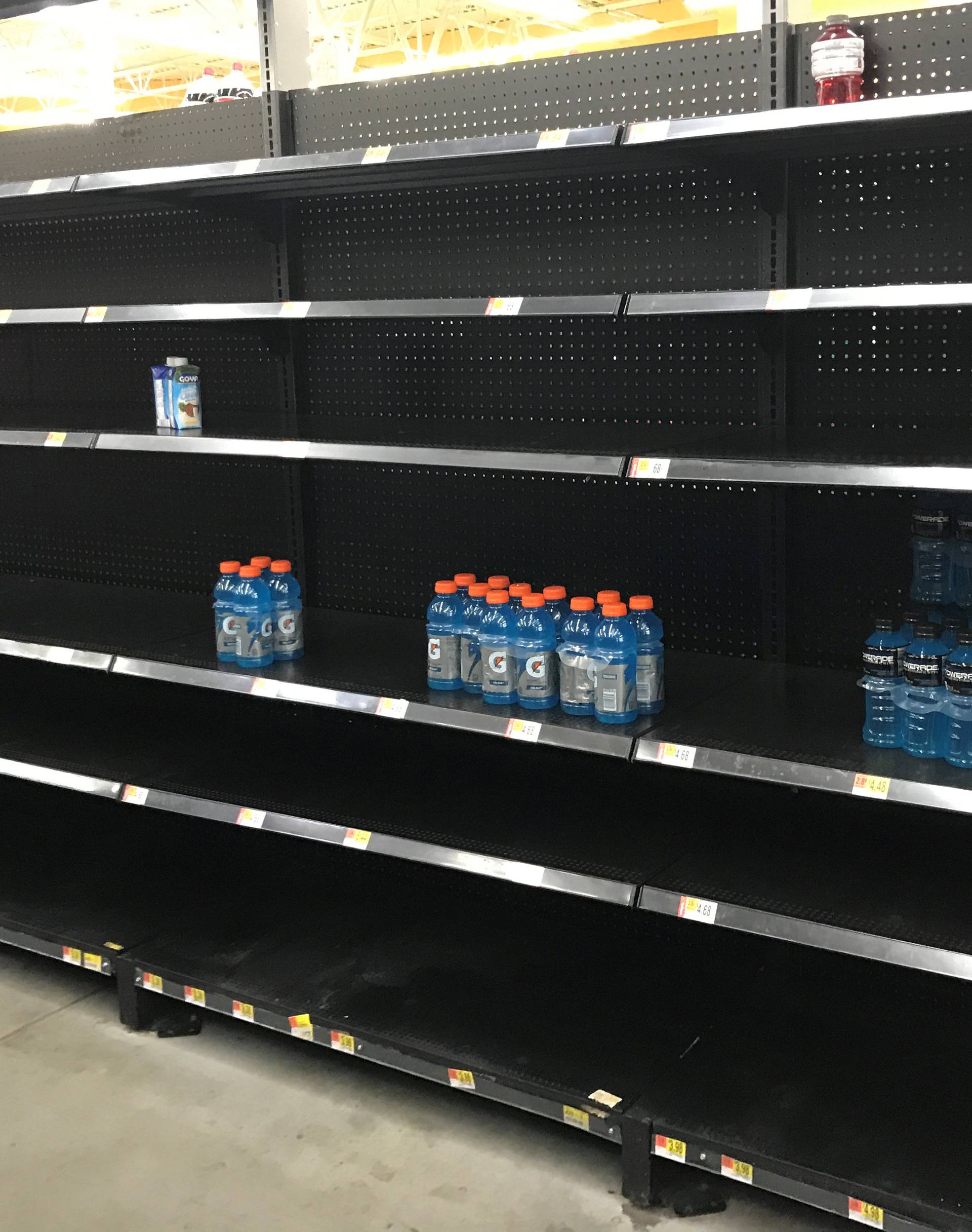 Shelves sit nearly empty in a Walmart store as residents stock ahead of Hurricane Harvey approaching landfall near the Texas coastal area, in Houston