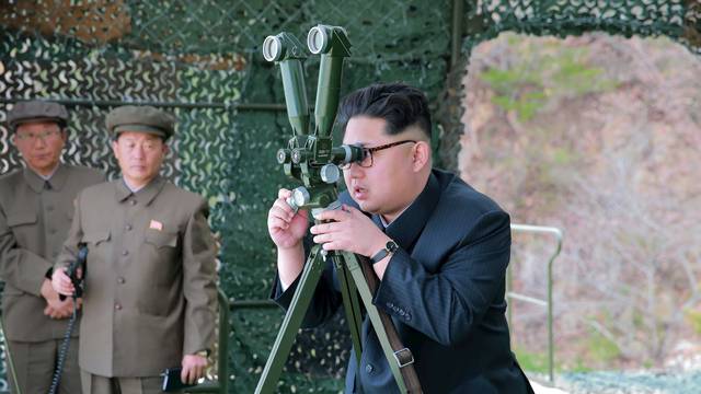 North Korean leader Kim Jong Un guides on the spot the underwater test-fire of strategic submarine ballistic missile
