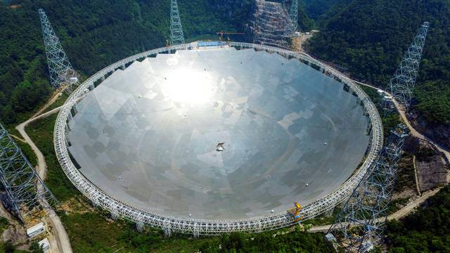 A 500-metre aperture spherical telescopeis seen at the final stage of construction, among the mountains in Pingtang county