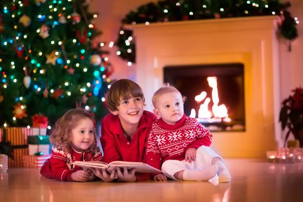 Kids playing at fireplace on Christmas eve