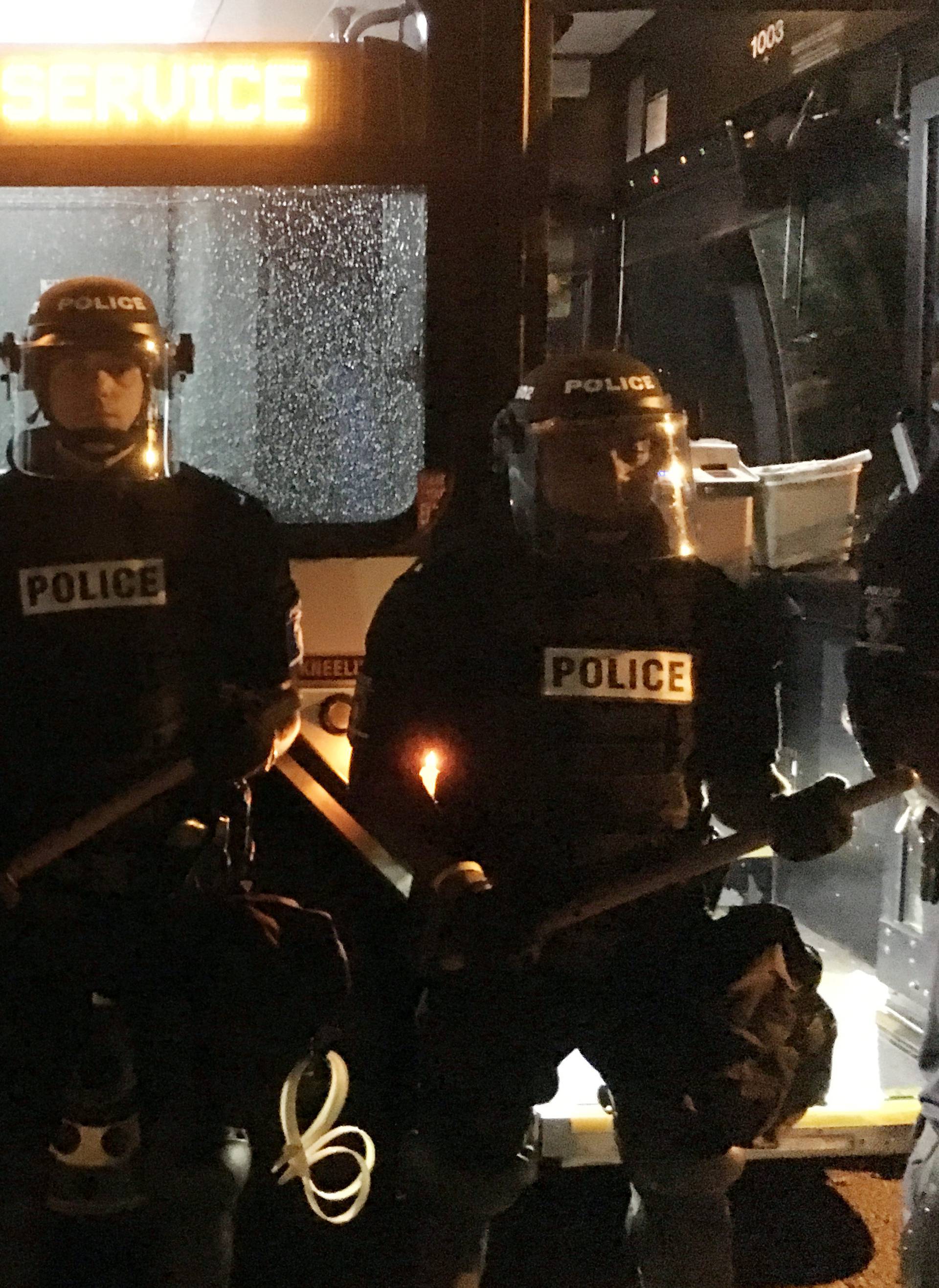 Police officers wearing riot gear block a road during protests after police fatally shot a man in the parking lot of an apartment complex in Charlotte
