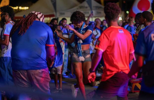 Fans of the Cape Verde national soccer team celebrate as they watch a World Cup group stage match against Uruguay in Praia