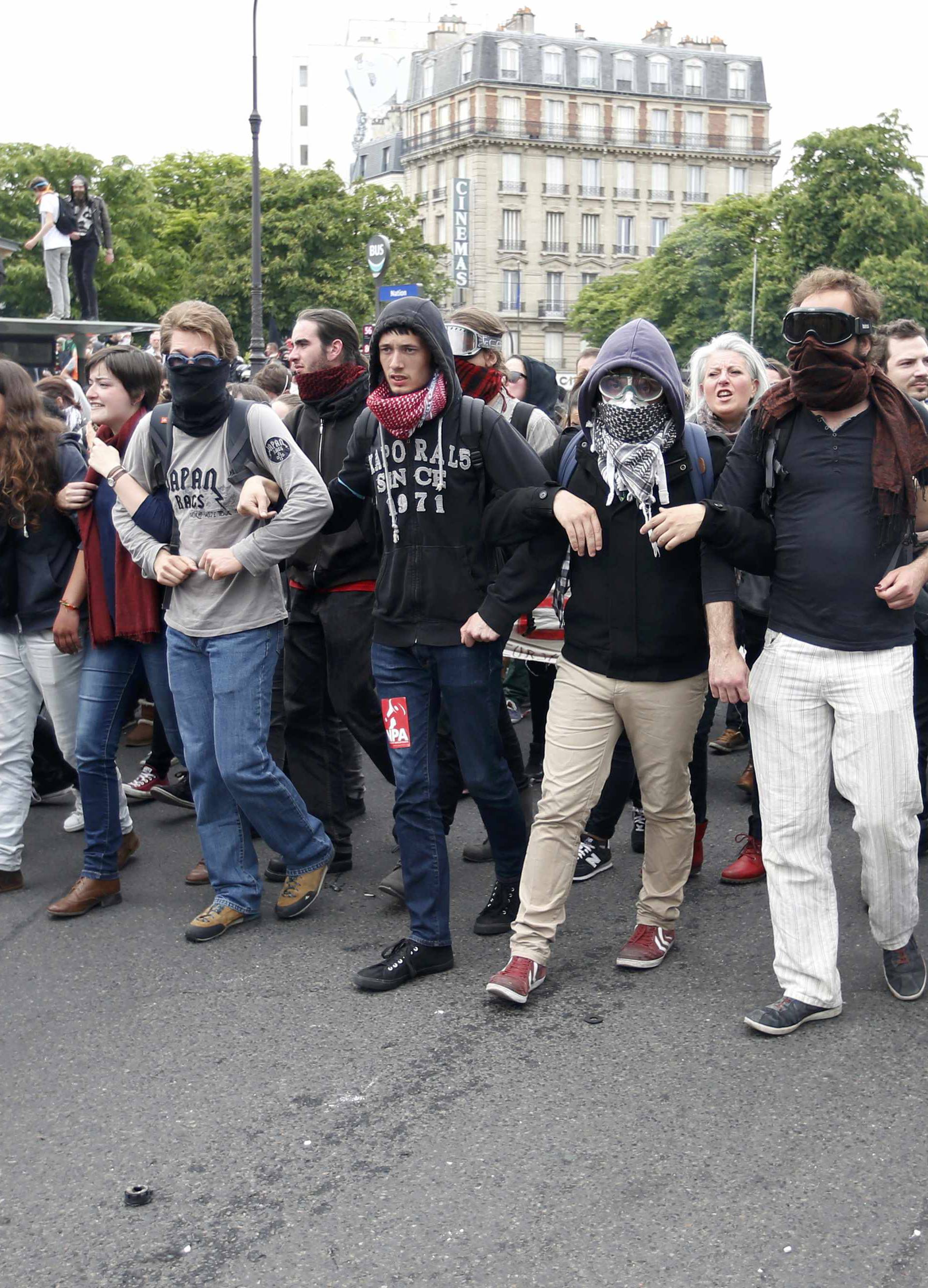  Masked youths take part in a demonstration in protest of the government's proposed labor law reforms in Paris