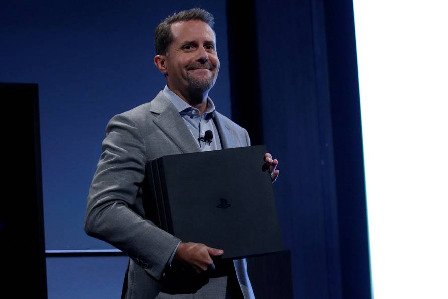 Andrew House, chief executive of Sony Interactive Entertainment, holds a PlayStation 4 Pro, during a launch event in New York