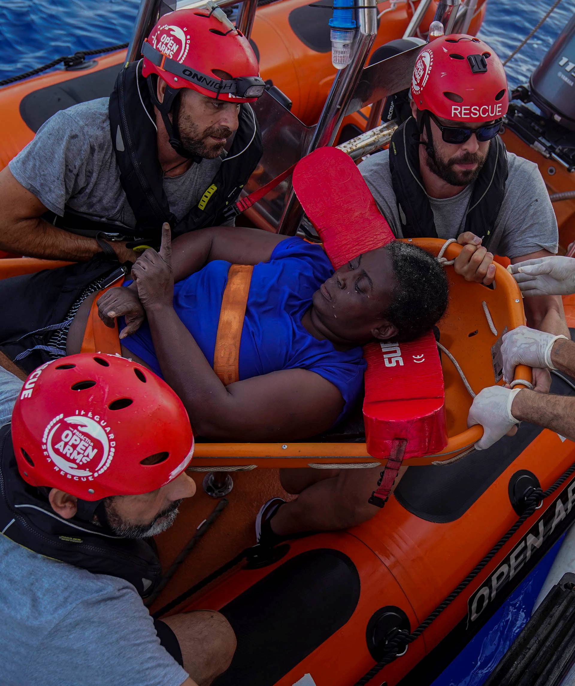 NBA Memphis player Marc Gasol and members of NGO Proactiva Open Arms rescue boat carry African migrant in central Mediterranean Sea