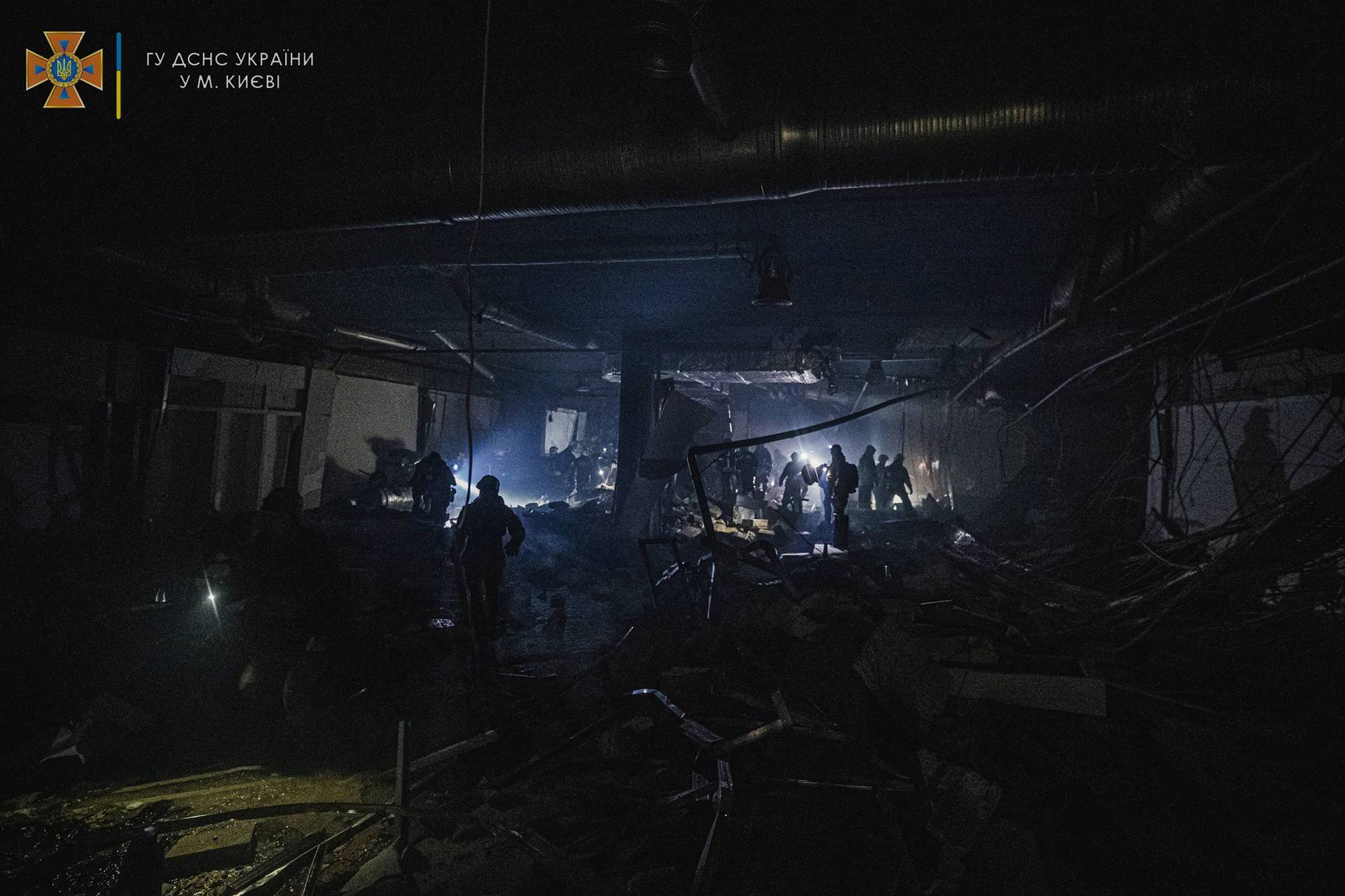 Rescuers work at the site of a shopping mall damaged by an airstrike in Kyiv