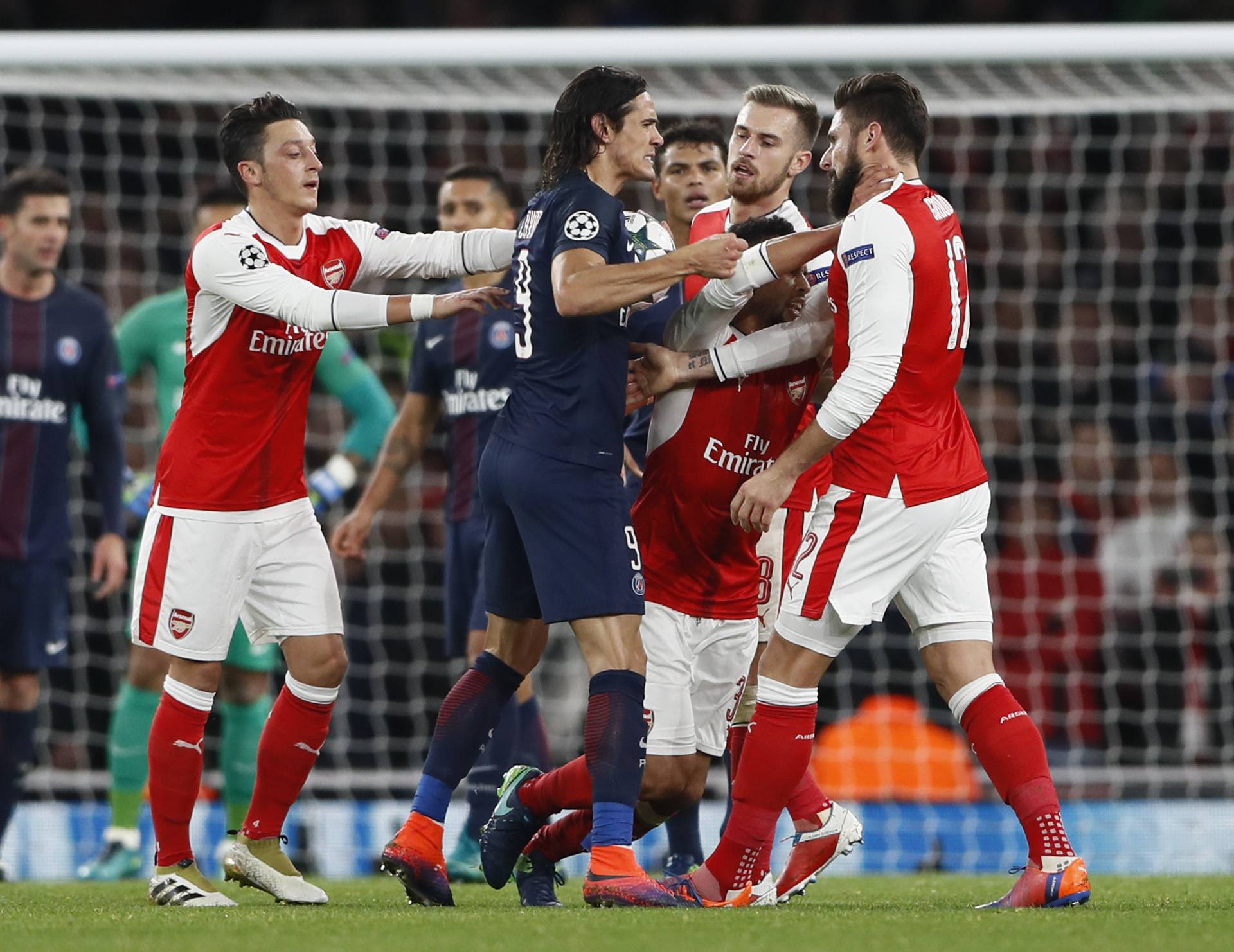Paris Saint-Germain's Edinson Cavani clashes with Arsenal's Aaron Ramsey, Francis Coquelin and Olivier Giroud as Mesut Ozil looks on