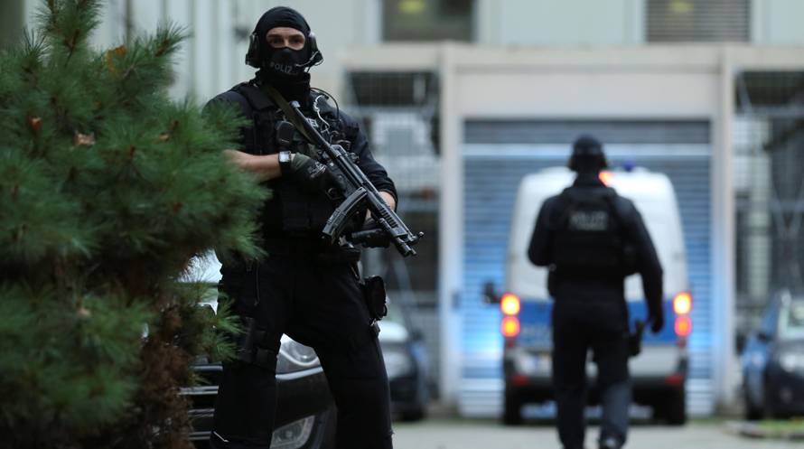 German special police arrive with a suspect of a planned bomb attack on behalf of the Islamic State militant group, at a courthouse in Frankfurt