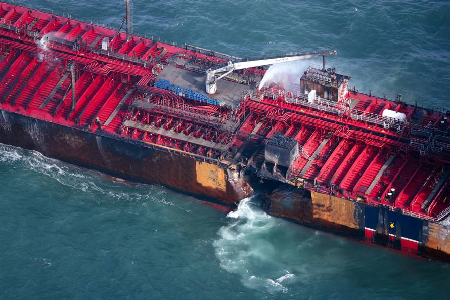 Aftermath of collision between container ship and oil tanker