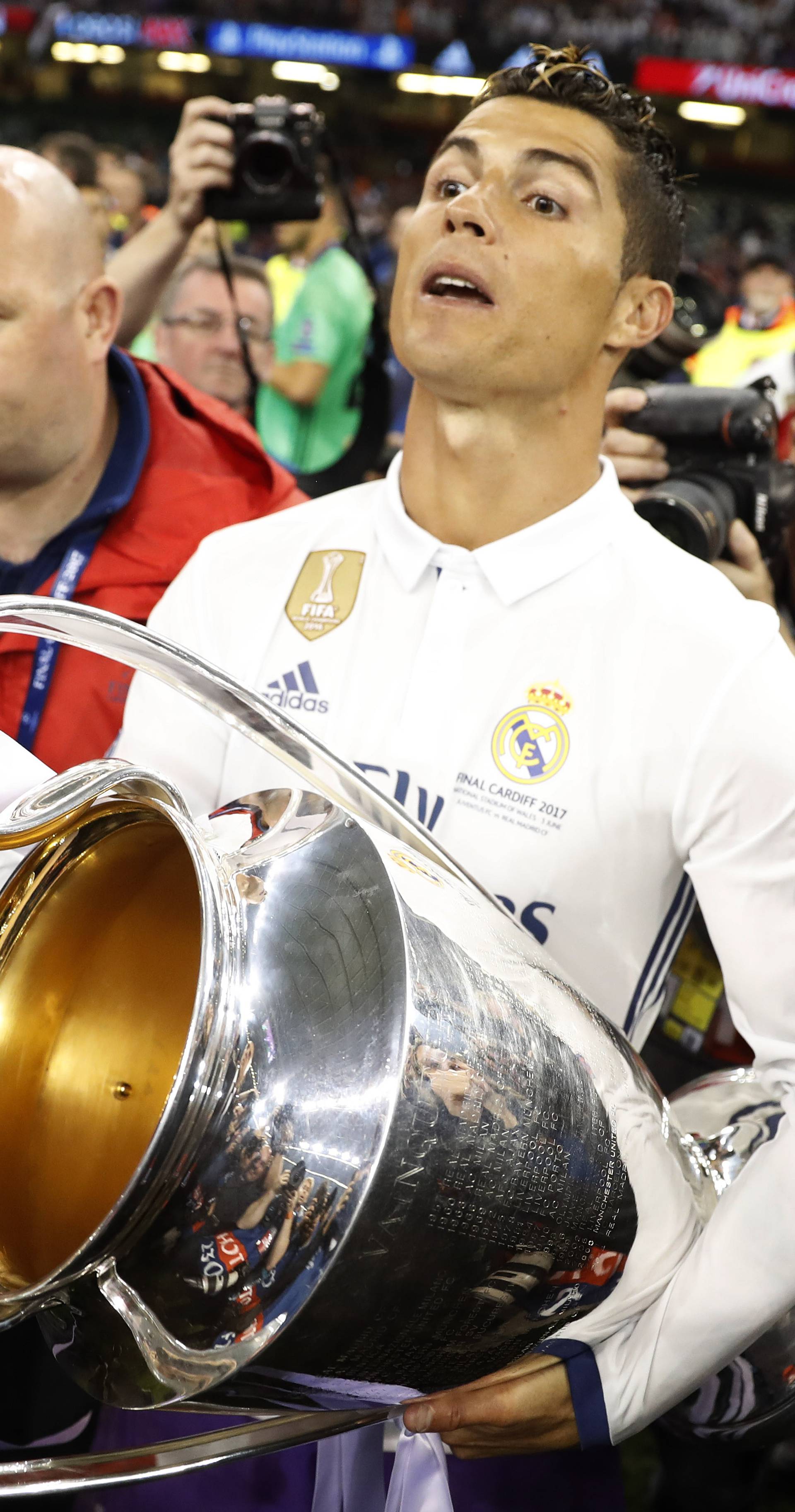 Real Madrid's Cristiano Ronaldo celebrates with the trophy after winning the UEFA Champions League Final