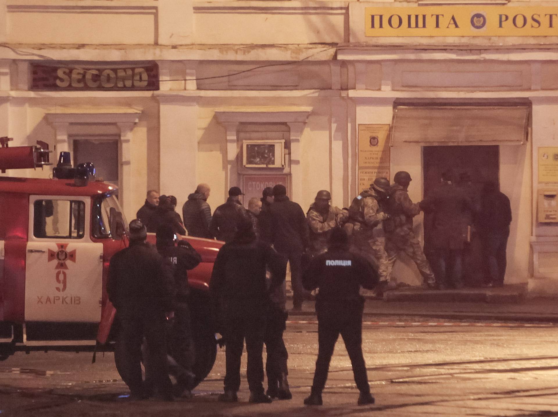 Members of a police special operations unit gather outside a post office, where a man took people hostage, in Kharkiv