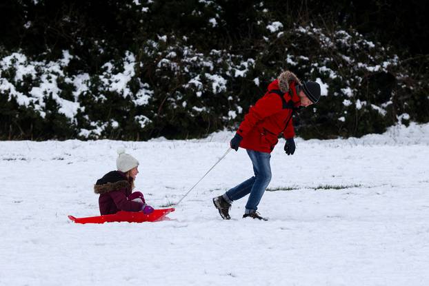 Andrew Hodgson pulls his daughter Emma in the snow