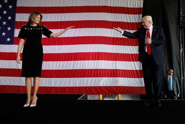 Trump and the first lady take the stage to rally with service members at Sigonella Air Force Base at Naval Air Station Sigonella at the end of Trump's participation in the G7 summit in Sicily, Italy