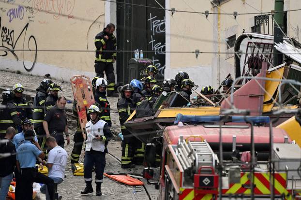 First responders work at the site of a funicular accident in Lisbon
