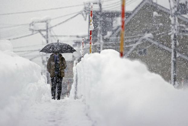 A man makes his way in the heavy snow in Uonuma